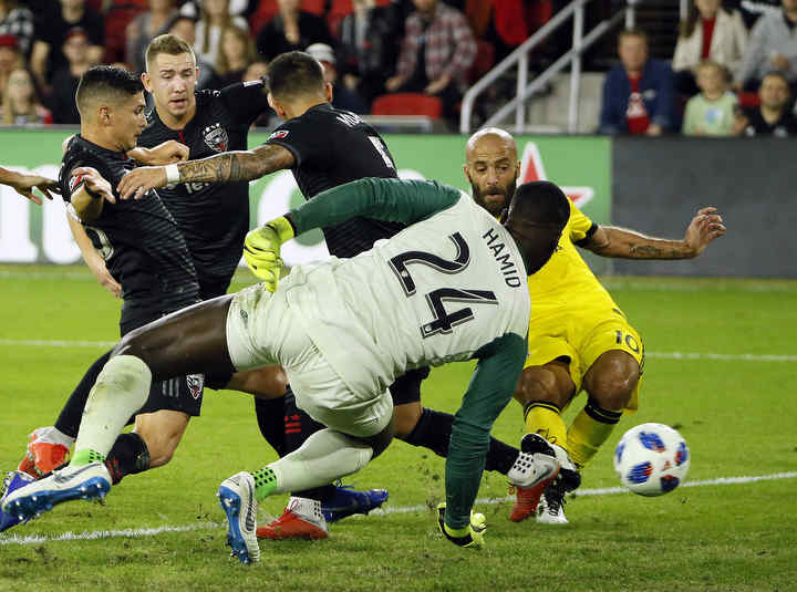 Columbus Crew SC forward Federico Higuain scores a goal past D.C. United goalkeeper Bill Hamid (24) during the first half of the knockout round playoff match at Audi Field in Washington, D.C.  (Adam Cairns / The Columbus Dispatch)